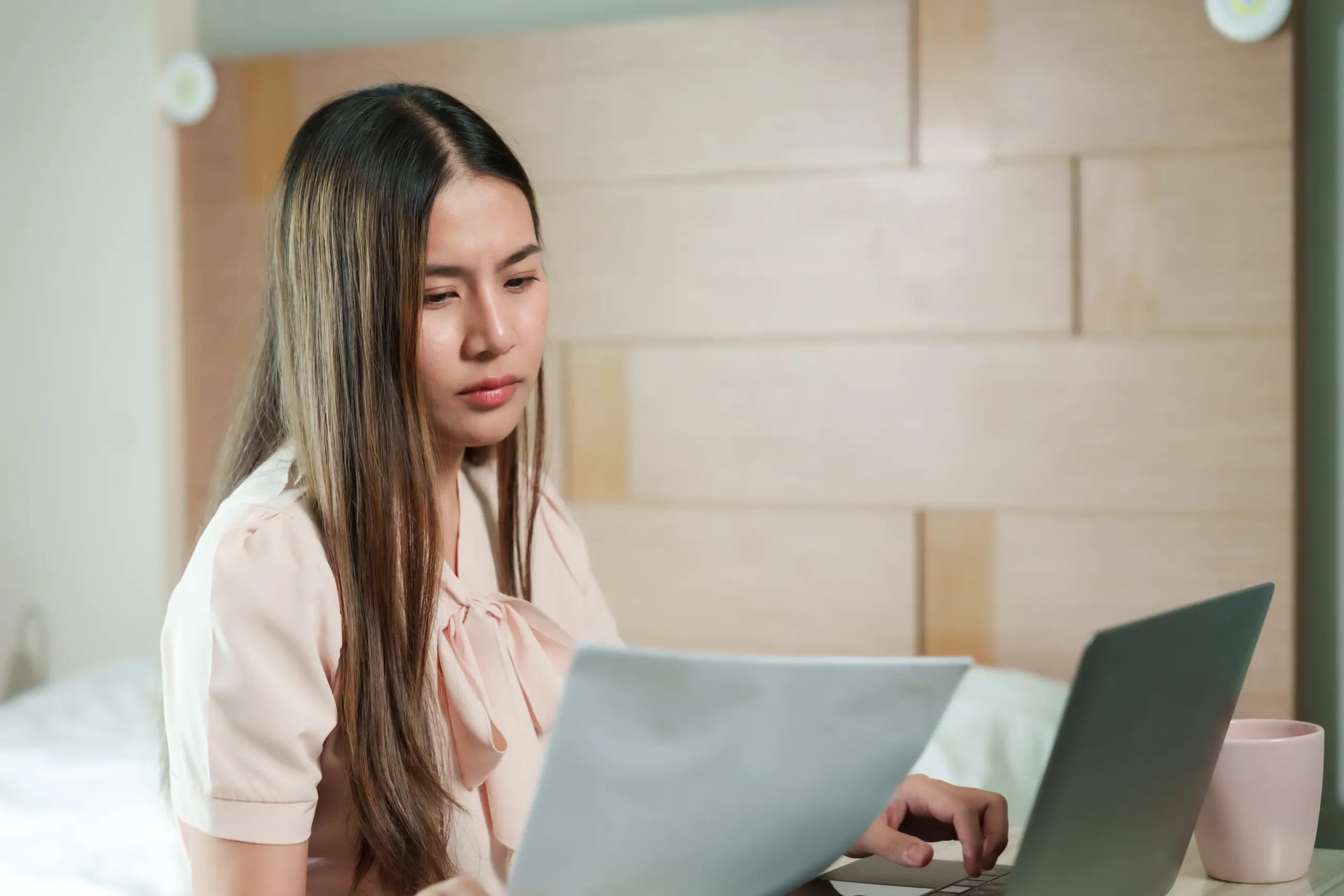 person stressed while reviewing bills related to addiction