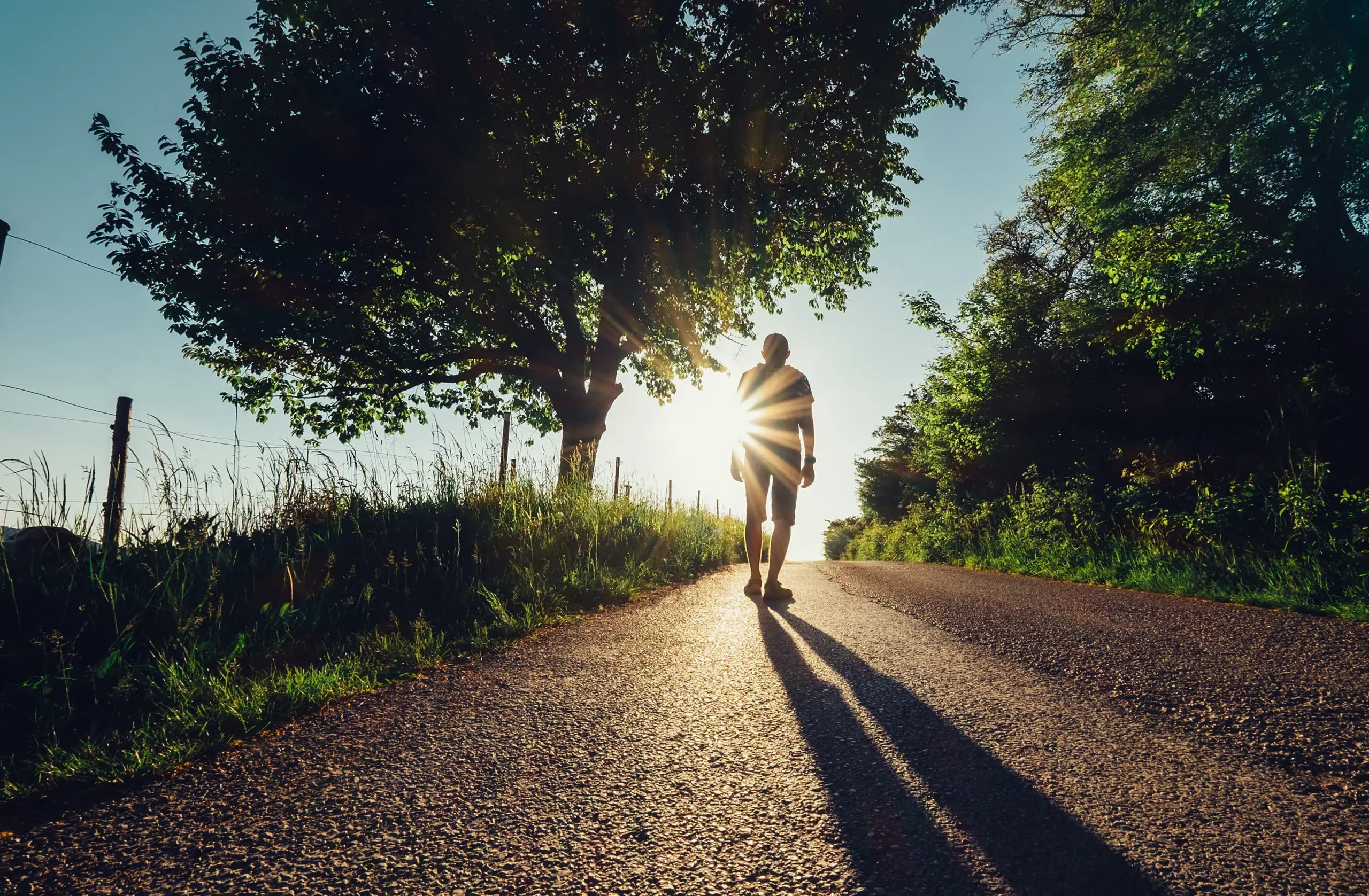 Individual walking a recovery path symbolizing commitment to completing rehab