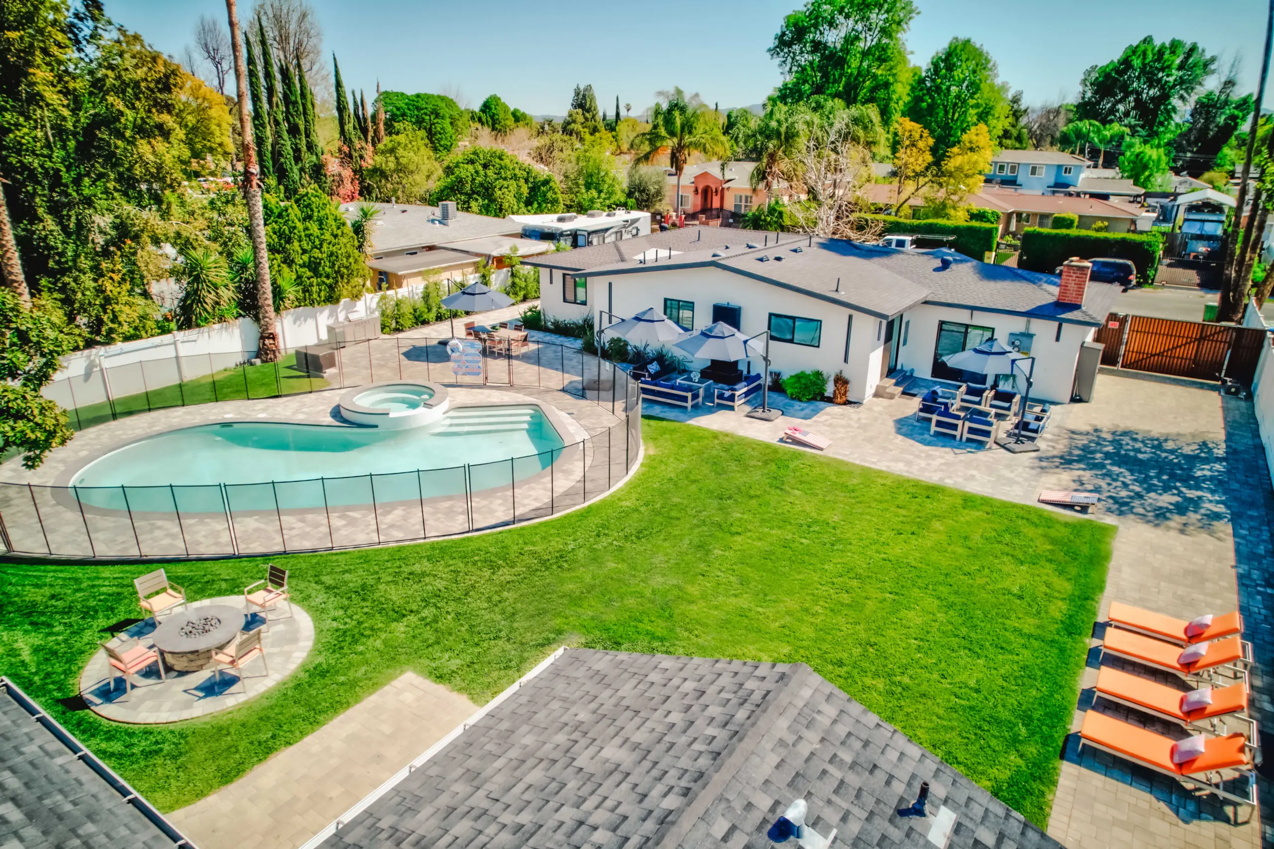 Peaceful outdoor setting at Deluxe Treatment Center showing a pool, lounge area, and calming green space for stress relief and recovery.