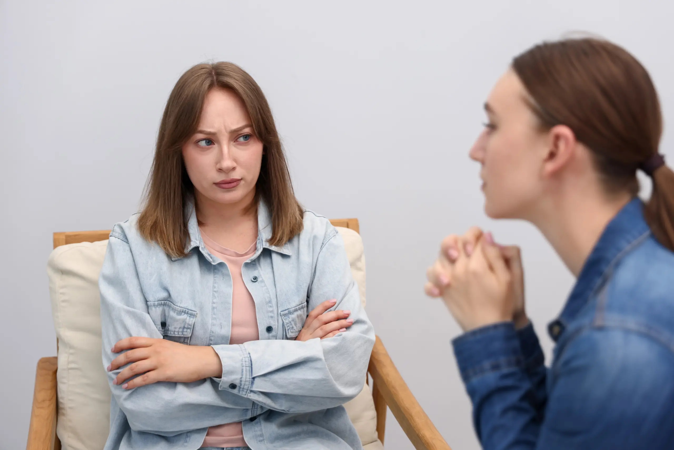 Two friends sitting apart, setting boundaries in recovery